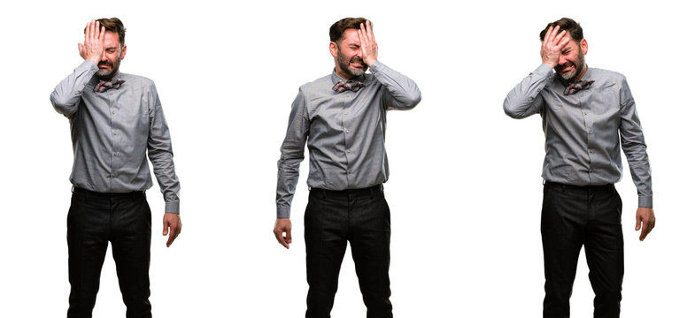 Middle age man, with beard and bow tie stressful keeping hand on head, tired and frustrated