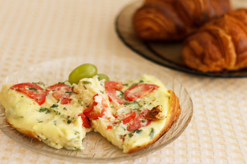Delicious magnificent omelet and croissant