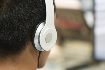 Education e-learning foreign languages Concept : Student Young man wearing Headphones listening...