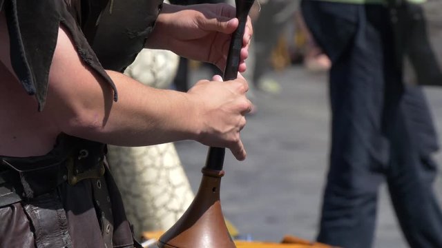 Close up of one person playing a medieval bagpipe
