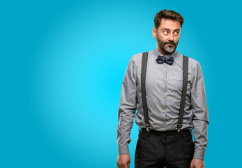 Middle age man, with beard and bow tie doubt expression, confuse and wonder concept, uncertain future