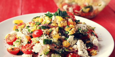 Colorful vegetable mix. Simple low calories salad. Cherry tomatoes, sweet corn, cucumber, bell pepper and cottage cheese. Weight loss dish. European cuisine.