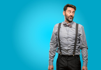 Middle age man, with beard and bow tie doubt expression, confuse and wonder concept, uncertain future