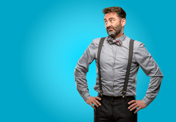 Fototapeta premium Middle age man, with beard and bow tie doubt expression, confuse and wonder concept, uncertain future