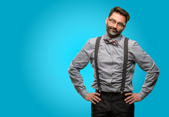 Middle age man, with beard and bow tie making funny face fooling