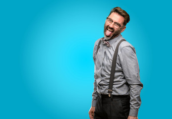 Middle age man, with beard and bow tie sticking out tongue at camera at sign of disobedience,...