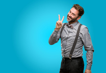 Middle age man, with beard and bow tie raising fingers, number two