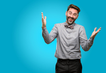 Fototapeta premium Middle age man, with beard and bow tie confident and happy with a big natural smile welcome gesture