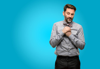 Middle age man, with beard and bow tie crying depressed full of sadness expressing sad emotion