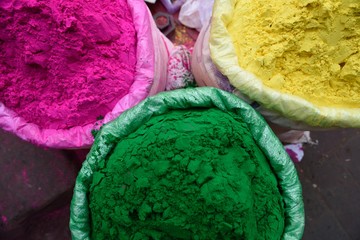 Containers of bright vivid Holi powders, for the Hindu festival of colours in New Delhi, India.