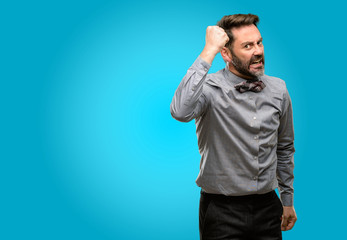 Fototapeta premium Middle age man, with beard and bow tie irritated and angry expressing negative emotion, annoyed with someone