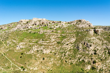 Fototapeta na wymiar Horizontal View of the Sassi of Matera on Blue Sky Background. Matera, South of Italy