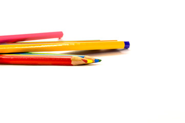 colored pencils lying on white background