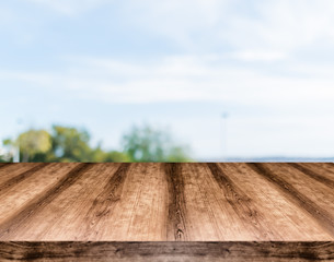 Wooden empty table board in front of blurred background. Can be used for display or montage any product. Mock up for display your product.