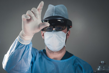 Surgeon using augmented reality holographic hololens glasses while operating in modern operation...