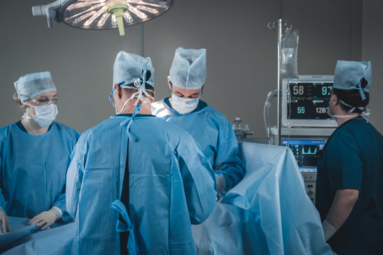 Medical team performing surgical operation in real modern operating theater