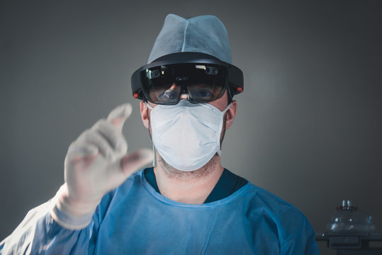Surgeon using augmented reality holographic hololens glasses while operating in modern operation theater