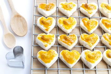Heart shape cookies with cashew nut or Singapore Cookie and wooden spoon on white table background for valentines day element concept design.