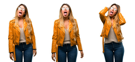 Beautiful young woman feeling disgusted with tongue out over white background