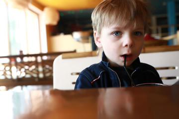 Fototapeta na wymiar Child drinking juice