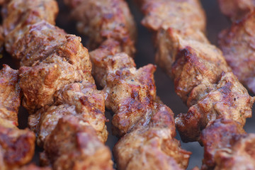 Fresh meat shish kebab fried and smoked on a charcoal grill. Roast the meat close up