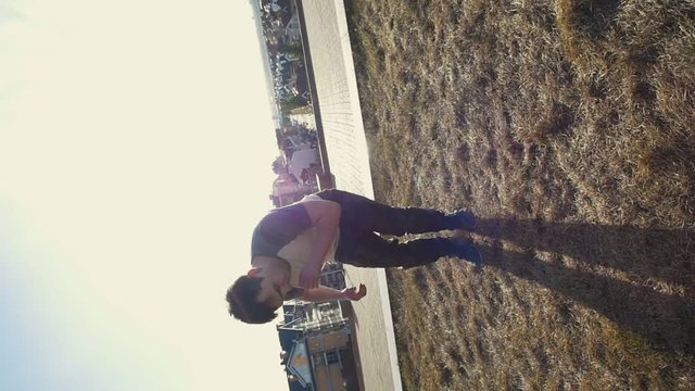 Young male Parkour tricker jumper performs amazing flips, silhouette