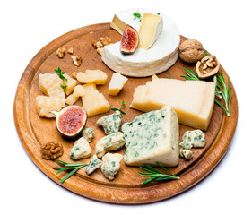various types of cheese - brie, camembert, roquefort and cheddar on wooden board