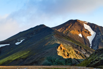 Fototapeta premium Icelandic mountain landscape at sunset. Colorful volcanic mountains in the Landmannalaugar geotermal area. One of the parts of Laugavegur trail