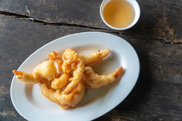 Fried prawn balls on a wooden table.