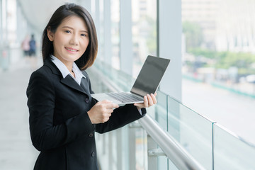 Fototapeta premium beautiful smart asian businesswoman short hair with black suit and blur background portrait profile photo