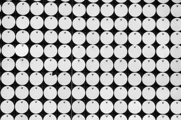 a wall of sparkling silver sequins close up . Front view