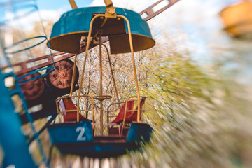 Fototapeta na wymiar Mechanism of an old Ferris wheel in a spring park. A cheerful spring day