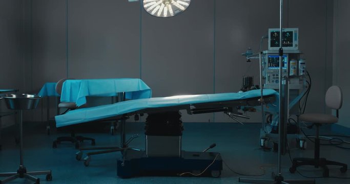 DOLLY IN WIDE view of an empty operating theatre in a modern clinic. 4K UHD 60 FPS SLO MO