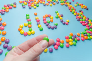 candy caramel lined word diet, on blue background, closeup