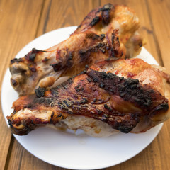 Appetizing roast turkey shank on a plate close up