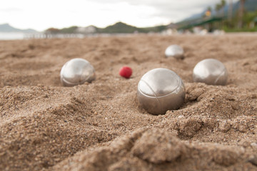 Fototapeta na wymiar Beach. A game of Bocha. Brilliant silver balls for a bocha on the sand.