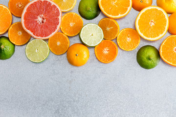 Mixed still life border of fresh cut citrus fruit