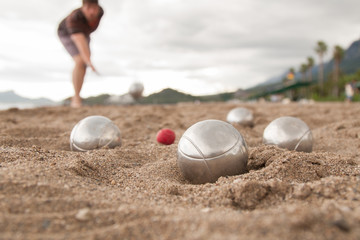 Beach. A game of Bocha. Brilliant silver balls for a bocha on the sand.