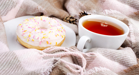 Obraz na płótnie Canvas Tea with donut. Romantic breakfast with sweets. Home cosiness.