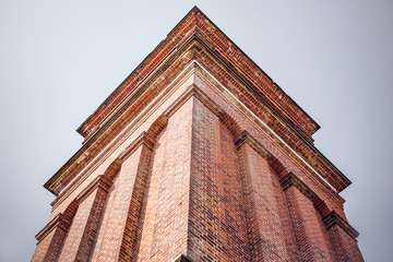 High tower with red bricks from below