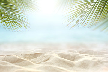 Plakat Sand with blurred Palm and tropical beach and sea background, Summer vacation and travel concept. Copy space