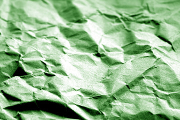 Old paper with wrinckles in green color.