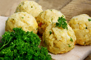 Homemade Fresh Bread dumpling.(German name is Semmelknödel)
European food with wooden board and parsley
