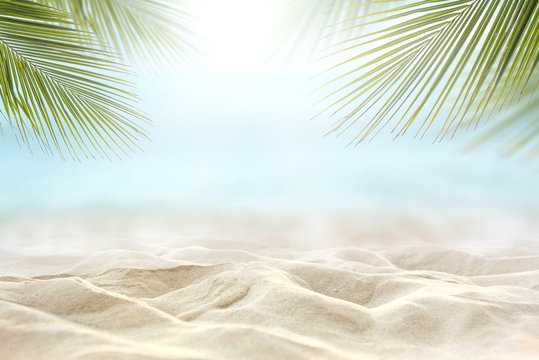 Sand with blurred Palm and tropical beach and sea background, Summer vacation and travel concept. Copy space