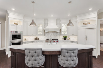 Kitchen in new luxury home: large, elegant kitchen, with pendant lights, and huge island, with...