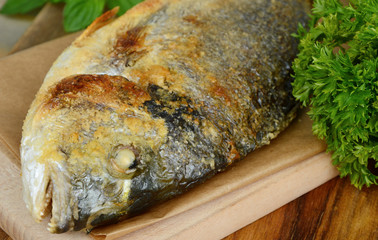 Salt Crusted Grilled Fish with wooden board.
Gilthead seabream grilled