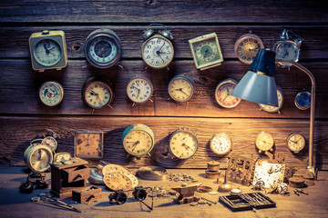 Watchmaker's workshop with many clocks, tools and spare parts