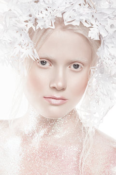 A very delicate portrait of an albino girl, a white background, snowflakes in her hair, sparkles, a magical winter image. Natural make-up, pink lipstick on lips.