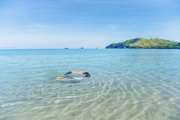 Fototapeta na wymiar Two little children snorkeling on the tropical beach