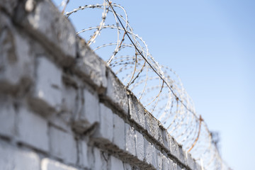 Barbed wire on a brick fence